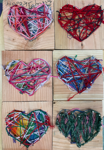 -primary students nailed heart-shaped outlines onto wood and wove yarn to fill the center for February, friendship and family month (grades K to 2)